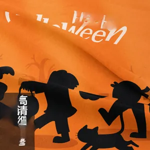 Close-up of orange Halloween tapestry fabric with Happy Halloween text and black print