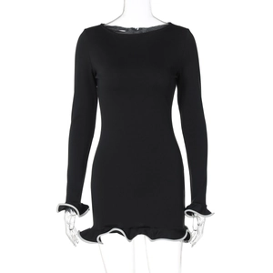 Detail showing white ruffled trim and cuffs on a black bodycon long sleeve dress