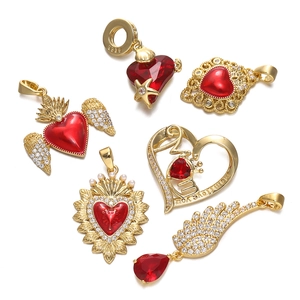 Macro detail of 18K gold plated heart pendants with red zircon and Mom I love you engraving