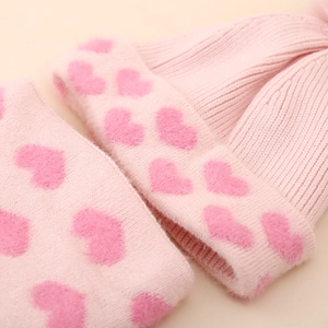 Detail of pink knitted winter set with jacquard heart pattern and soft fleece lining