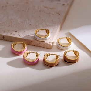 Macro shot of colorful enamel hoop earrings in gold plated stainless steel
