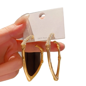 Luxurious gold bamboo-style hoop earrings with sparkling cubic zirconia on S925 silver pins