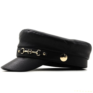 Detail view of black faux leather military cap with golden horsebit metal chain decoration