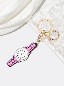Close-up of pink watch-shaped acrylic keychain with golden metal ring and lobster clasp