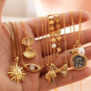 Golden sun and bow pendant necklace set with vintage coin and pearl details for women