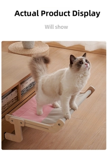 Ragdoll cat standing on a solid wood hanging window bed with pink and gray canvas fabric