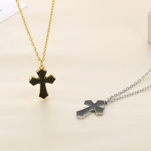 Detail of hip hop style cross necklaces in gold and silver finish with beaded edges