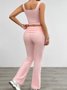 Rear view of pink two-piece knit set featuring a sleeveless crop top and flared pants