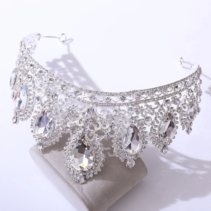 Detail of silver bridal crown with shimmering pear-cut rhinestones on a velvet stand