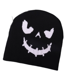 Close-up of the black knit beanie fabric showing detailed weave and white pumpkin face pattern