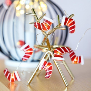 Detail of Christmas stocking LED string lights on golden reindeer antlers decor