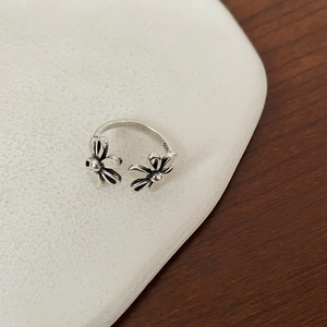 Close-up of the S925 sterling silver stamp on the inner band of the floral ring