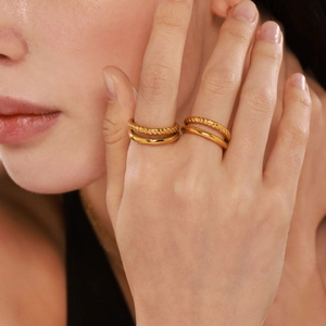 Double-layered 18k gold plated stainless steel twist ring worn on finger