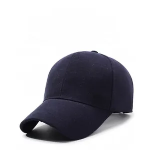 Detail view of the navy blue baseball cap fabric texture and silver metal side logo