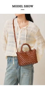 Brown hand-woven leather tote bag worn as crossbody with premium texture and model detail