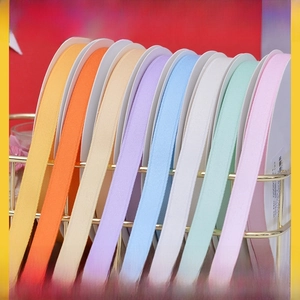 Detail of matte cotton-polyester ribbons in vibrant colors with knitted texture