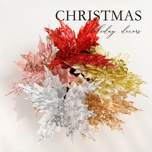 Glittery Christmas flowers in gold and red for festive tree decoration and home holiday decor