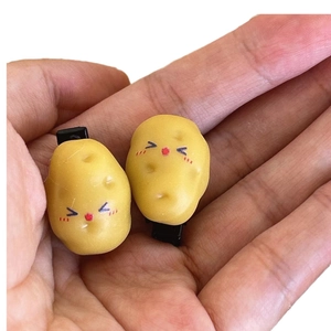 Funny 3D simulation potato hair clips with cute facial expressions on palm