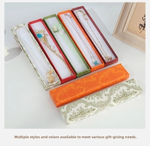 Close-up of assorted vintage rectangular jewelry gift boxes with floral and pearl accessories