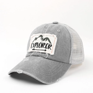 Close-up of grey washed cotton trucker hat with Explorer patch and mesh back