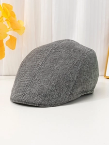 Close-up of the breathable dark grey linen fabric texture on this stylish flat cap
