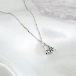 Silver cross chain necklace with hand-shaped pendant and sparkling clear zircon stone