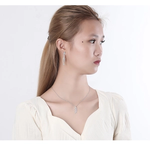 Close-up of elegant S925 sterling silver leaf pendant necklace and dangling earrings