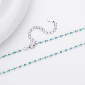 Detail of S925 sterling silver chain featuring turquoise beads and lobster clasp
