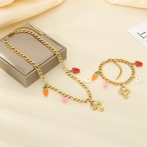 Detailed shot of golden stainless steel necklace and bracelet with colorful vegetable charms