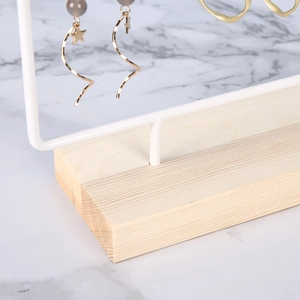 White iron jewelry display stand with solid wood base and earring hanging holes