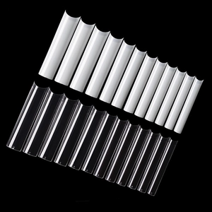 Macro detail of long C-curve nail tips in clear and natural white with 12 size options