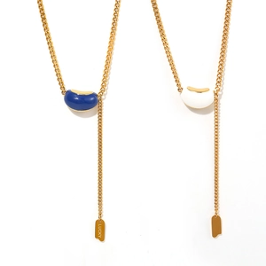 Golden bean pendant necklace with blue and white enamel detailing and Lucky charm tag