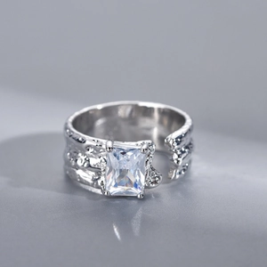 Macro shot of irregular silver open ring with large rectangular cut zircon stone