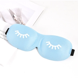 Close-up of a light blue 3D sleep mask with white eyelash pattern on a white surface