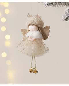 Close-up of plush angel doll ornament with gold sequins and bells on a Christmas tree