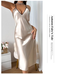 Detailed view of champagne satin slip dress with deep V-neck and black contrast piping