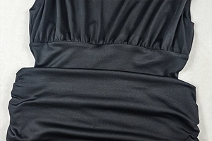 Macro shot of black ruched fabric detailing with glossy texture and pleated craftsmanship