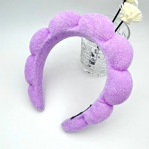 Detail of lilac sponge headband showing plush terry cloth texture for skincare