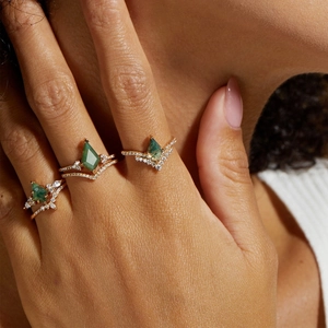 Elegant gold stacked rings with kite-cut green moss agate stones shown on model hand