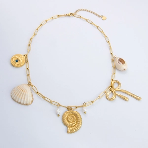 Detail view of 18K gold plated shell necklace with pearl, conch and evil eye charms