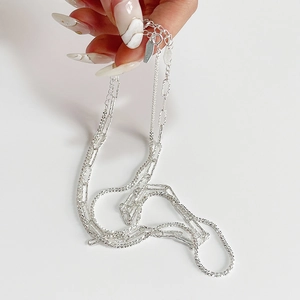 Close-up of double-layered 925 sterling silver chain with lobster clasp and S925 hallmark