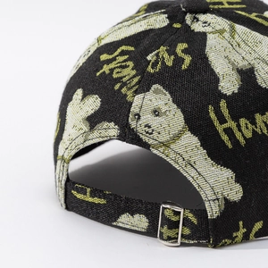 Detail of black baseball cap back with cartoon bear embroidery and metal buckle strap