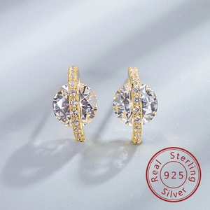 Macro detail of S925 sterling silver planet earrings with sparkling round cubic zirconia