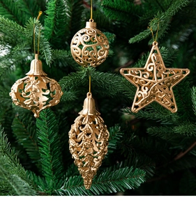 Close-up of golden hollow Christmas ornaments hanging on a festive green pine branch