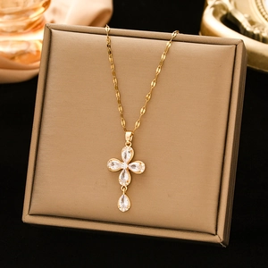 Minimalist gold stainless steel cross necklace with zircon stones on jewelry box