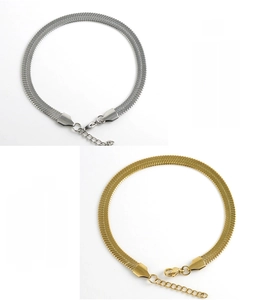 Detail of silver and gold stainless steel herringbone chains with high polish finish