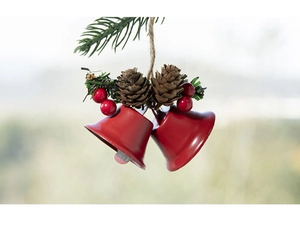Detail of red metal Christmas bells with pine cones and red berries on jute rope