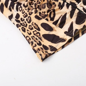 Detailed view of leopard print fabric texture and high-quality stitched hem on the sleeve
