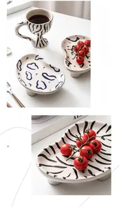 Detailed view of hand-painted zebra pattern ceramic goblet and textured matching plates