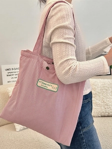 Plaid canvas tote bag with red and white grid pattern and top shoulder straps